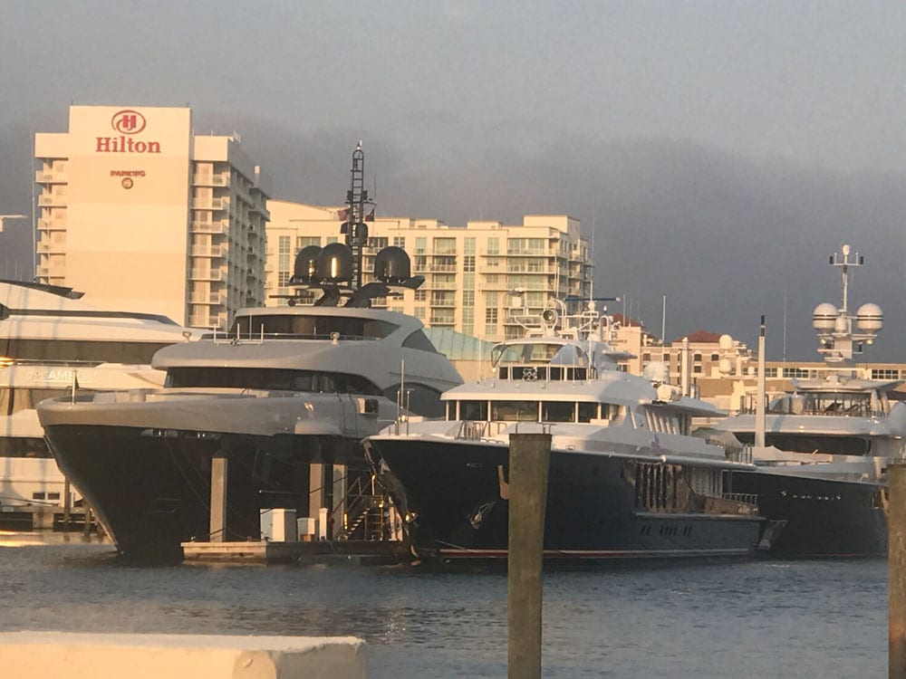 Yachts on the dock with buildings in the background