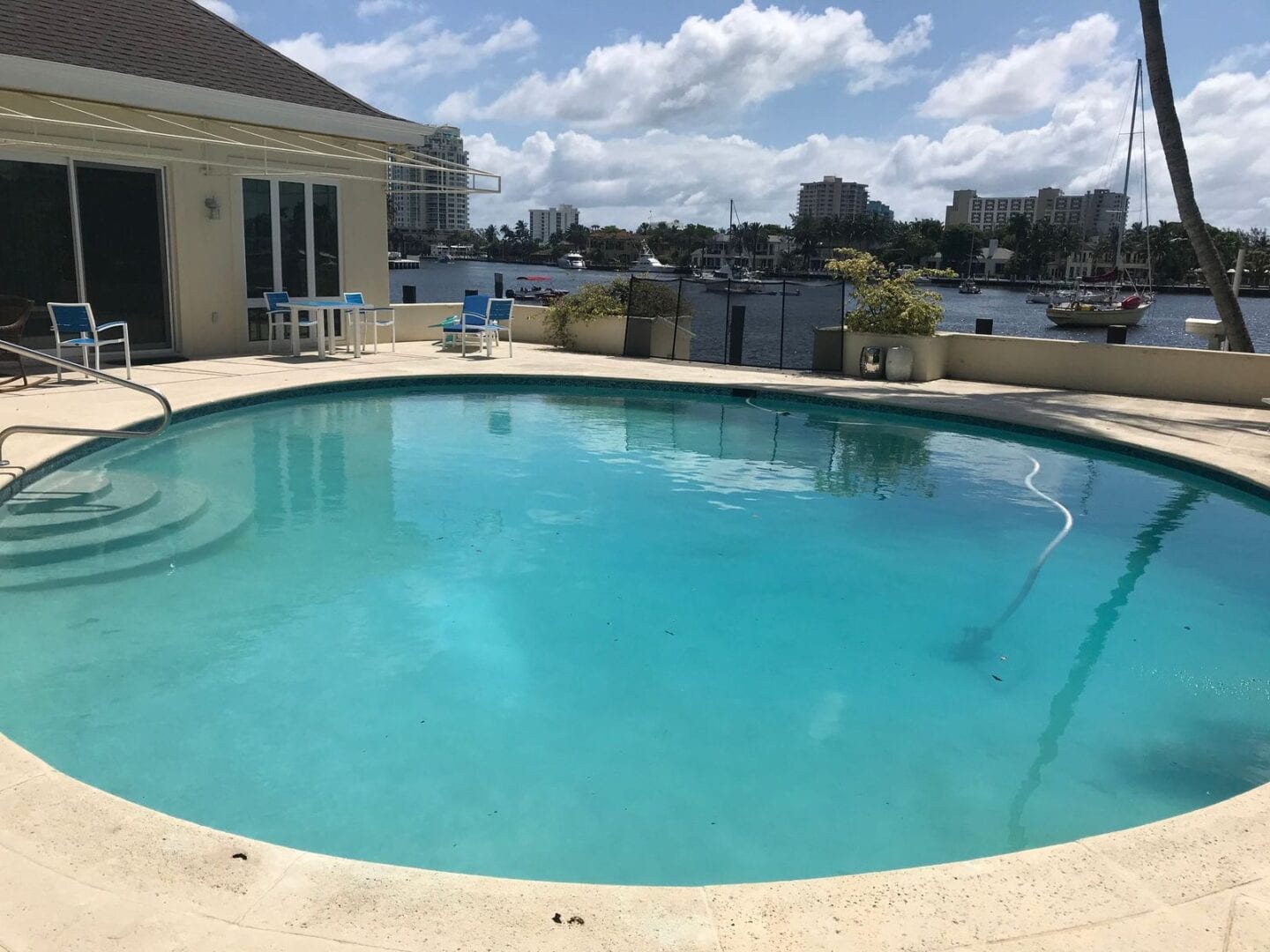 A pool with a view of the water and sky.