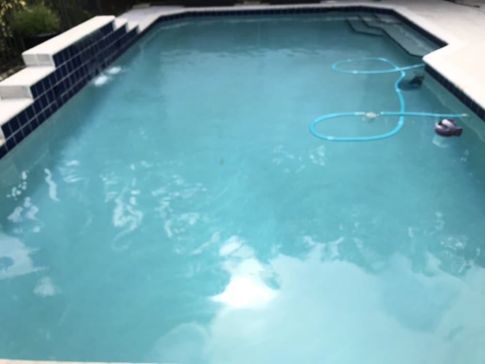 A pool being vacuumed (blurry)